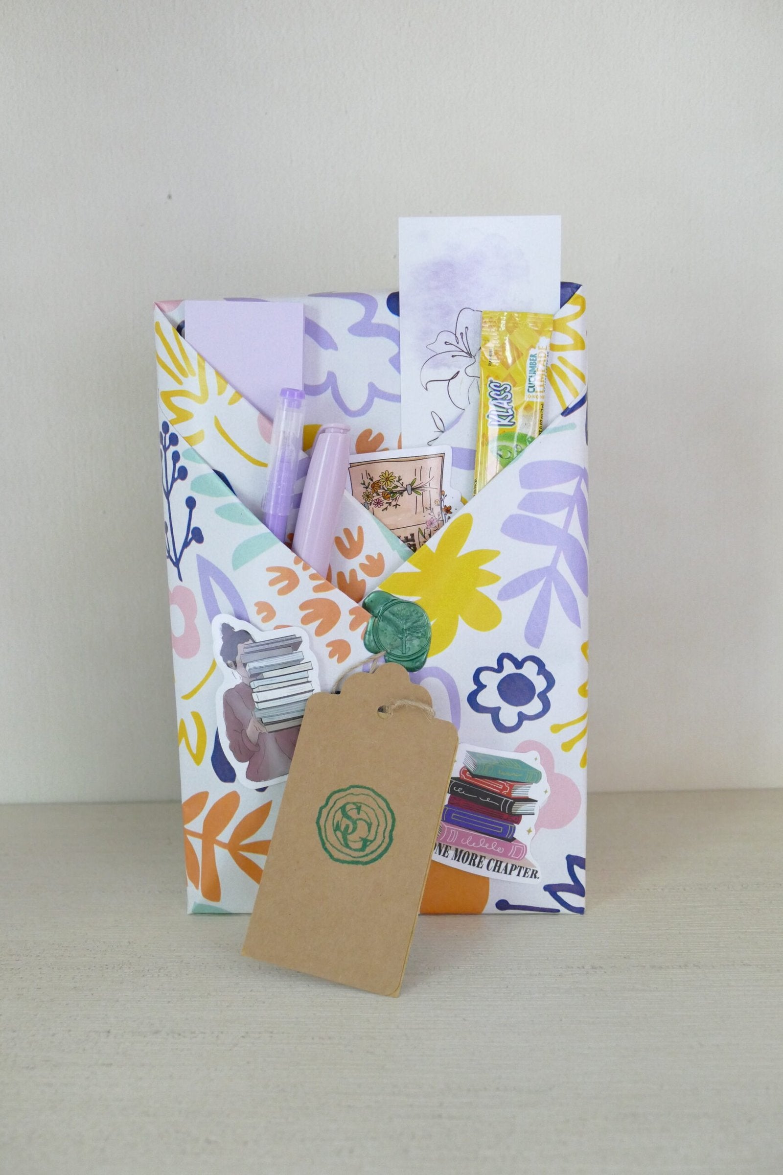 Surprise wrapped book with bright floral doodle design – mystery novel | The Story Grove