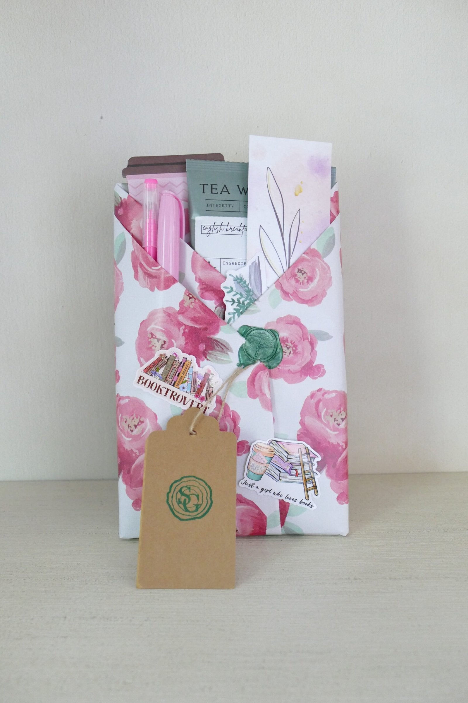 Surprise wrapped book with pink watercolor roses – historical fiction mystery | The Story Grove