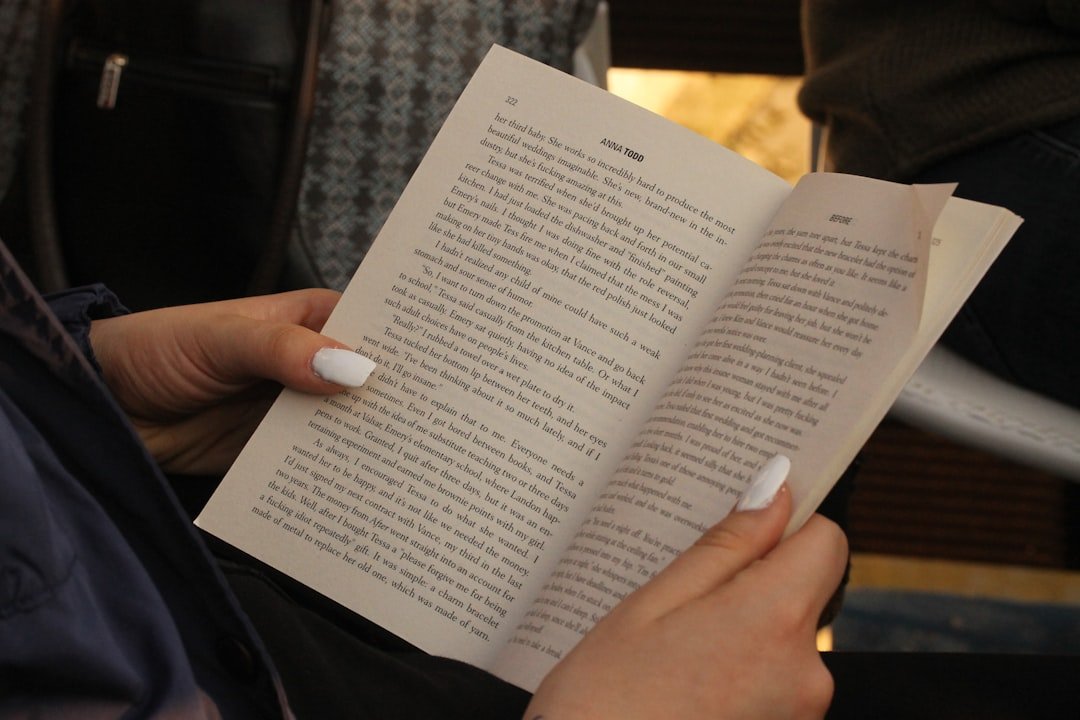 Hands holding an open book in soft natural light